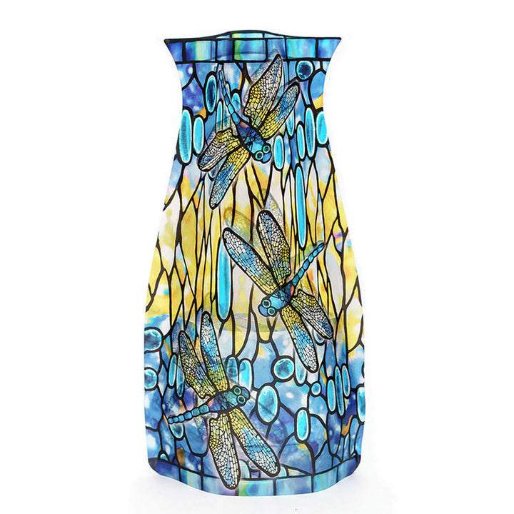 The Louis Comfort Tiffany Dragonfly Expandable Vase showcases a blue, yellow, and turquoise stained glass pattern with three large dragonflies and abstract shapes that evoke water and reeds.