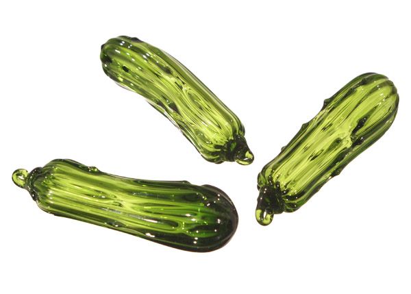Three Hand Blown Glass Pickle Ornaments feature transparent green glass with darker accents, arranged on a white background—perfect for adding a fun and traditional touch to your holiday decor.