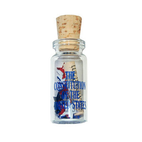The Mini US Constitution in a Bottle features a small glass container with a cork, holding a rolled-up scroll and red, white, and blue confetti—a unique patriotic gift or American history keepsake.