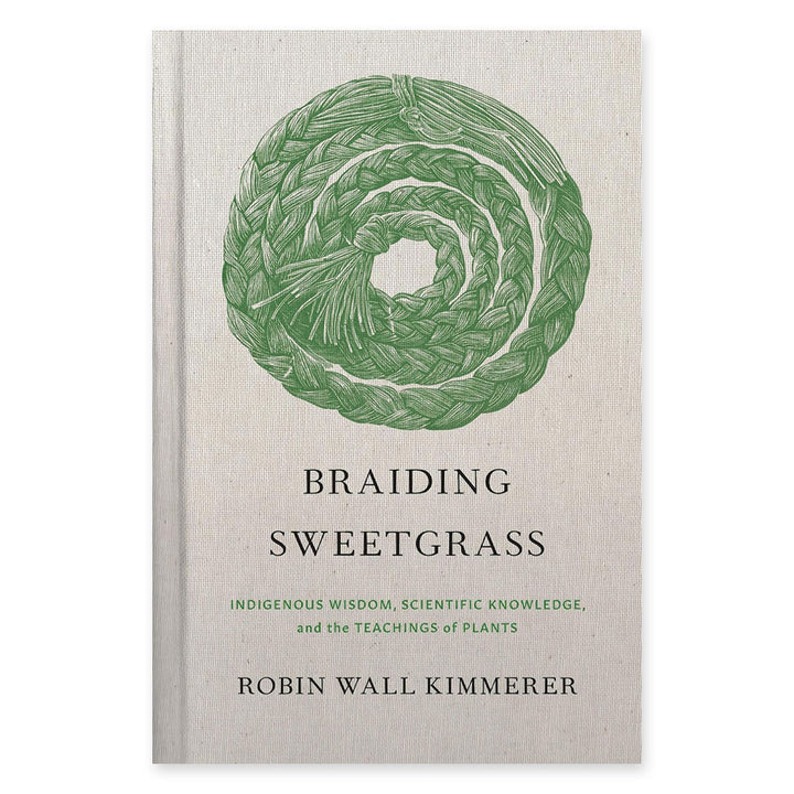 The cover of Braiding Sweetgrass: Indigenous Wisdom, Scientific Knowledge and the Teachings of Plants features a green braided spiral and displays the book’s full title by Robin Wall Kimmerer.