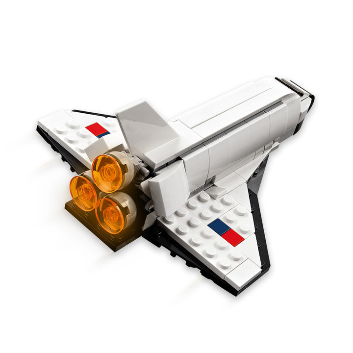 A LEGO Space Shuttle model featuring white wings with black edges, three orange engine thrusters, and small red and blue stickers on each wing is shown from the rear and slightly above on a white background—an ideal addition to any space shuttle playset and fully compatible with the interactive LEGO Builder app.