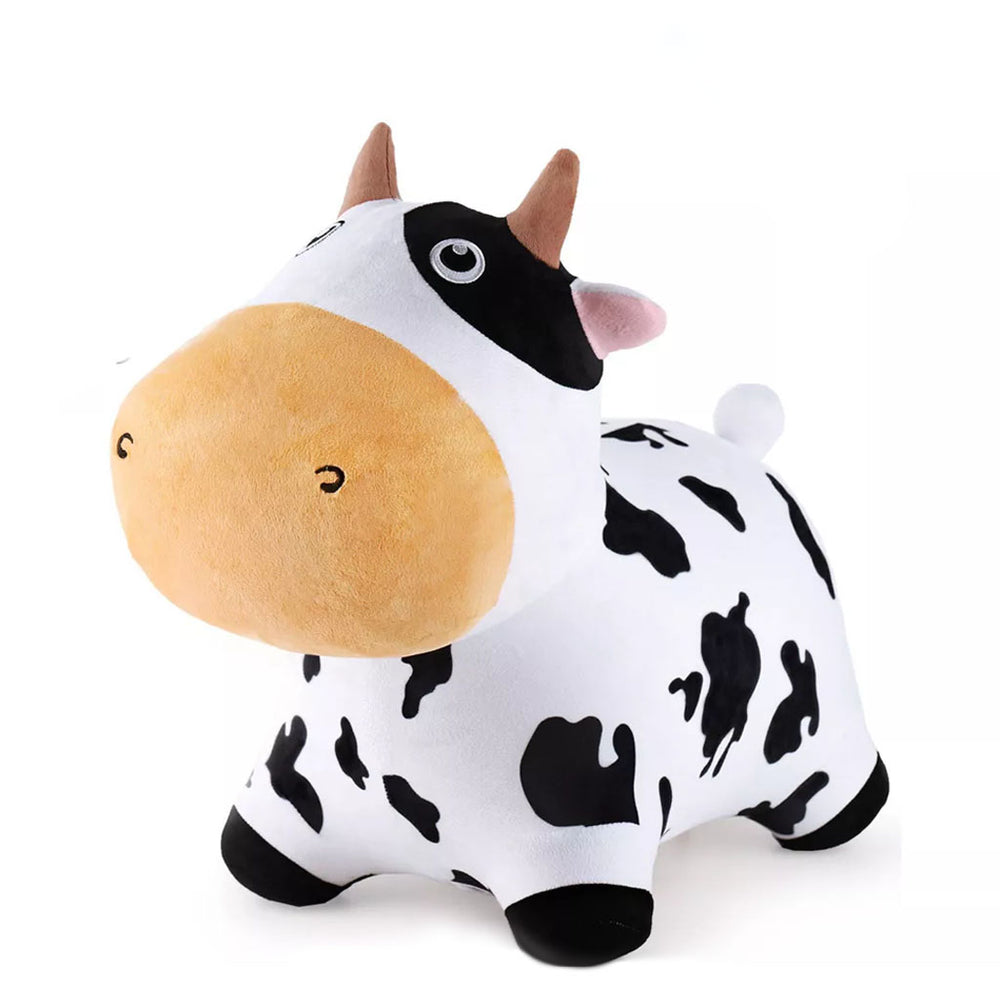 The Bouncy Pals Cow is a plush toy with black and white spots, small brown horns, a large tan snout, and a cute cartoon expression, shown on a plain white background.