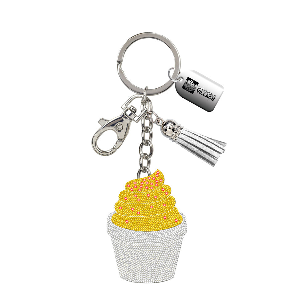 The Greenfield Village Frozen Custard Bling Keychain features a glittery yellow soft-serve ice cream charm in a white cup, silver tassel, lobster clasp, and a small tag on the key ring.