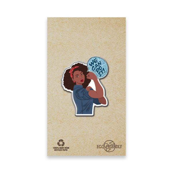 The Rosie the Riveter We Can Do It Pin features a woman with curly hair and a red bandana flexing her arm in the iconic World War II pose, styled like commemorative pins, set against eco-friendly recycled brown paper.