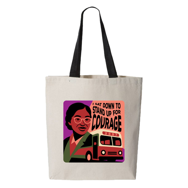 The Henry Ford® Rosa Parks Tote: a beige canvas bag with black handles, featuring an illustrated Rosa Parks, a bus, and "I sat down to stand up for courage" plus 2857 in bold colors—an exclusive tote from The Henry Ford.