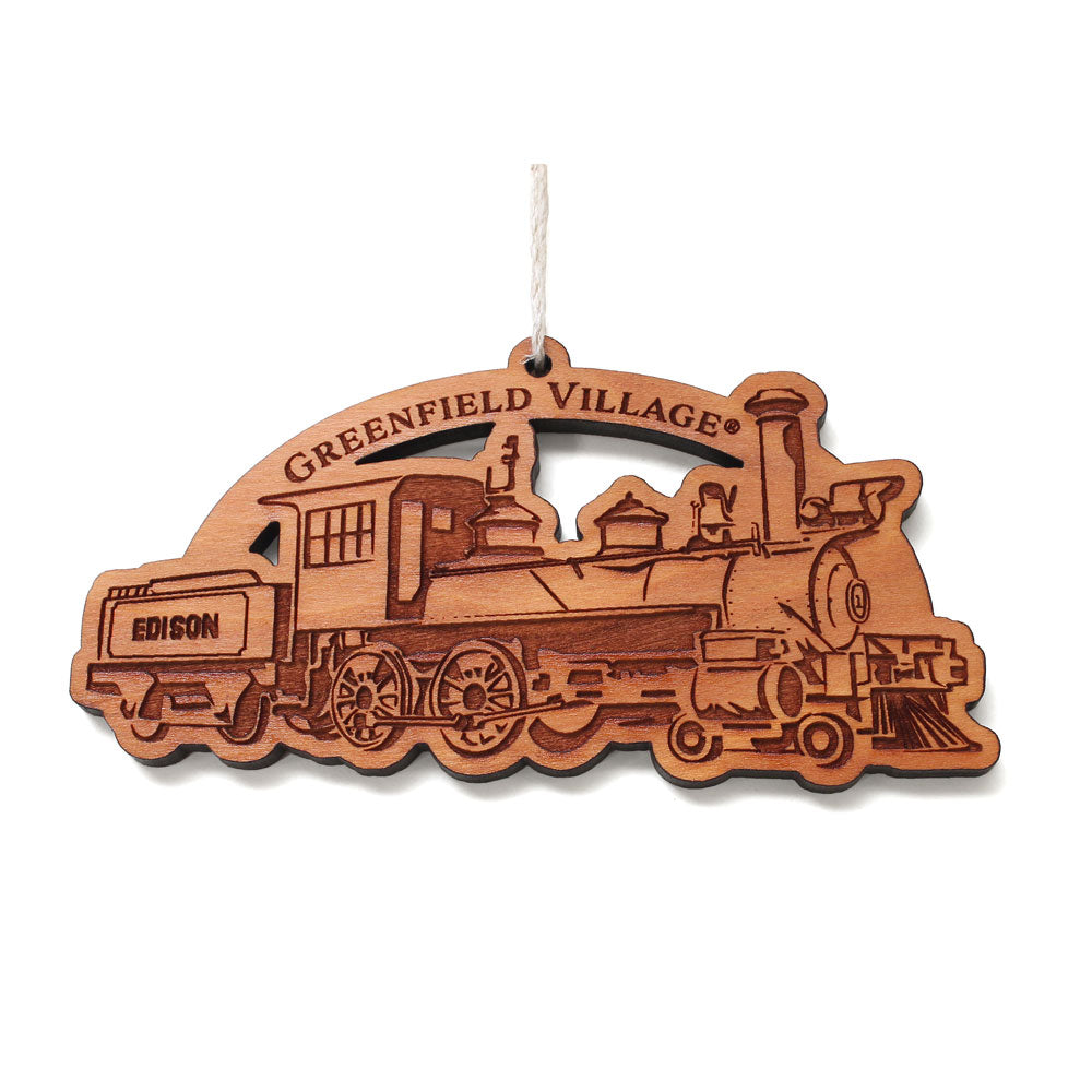 The Greenfield Village Train Ornament is a delightful wooden decoration showcasing a vintage steam engine, with “GREENFIELD VILLAGE” engraved above and “EDISON” displayed on the cab. Perfect as a Michigan souvenir, this ornament comes ready to hang and makes an ideal keepsake for train enthusiasts and collectors.