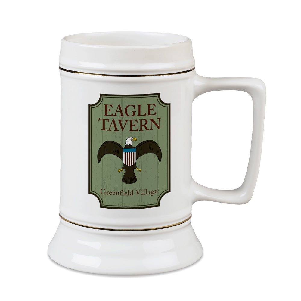 The Greenfield Village Eagle Tavern Stein is a white ceramic stein showcasing an eagle illustration and Greenfield Village logo on a green background—a perfect tribute to the spirit of 19th-century America.