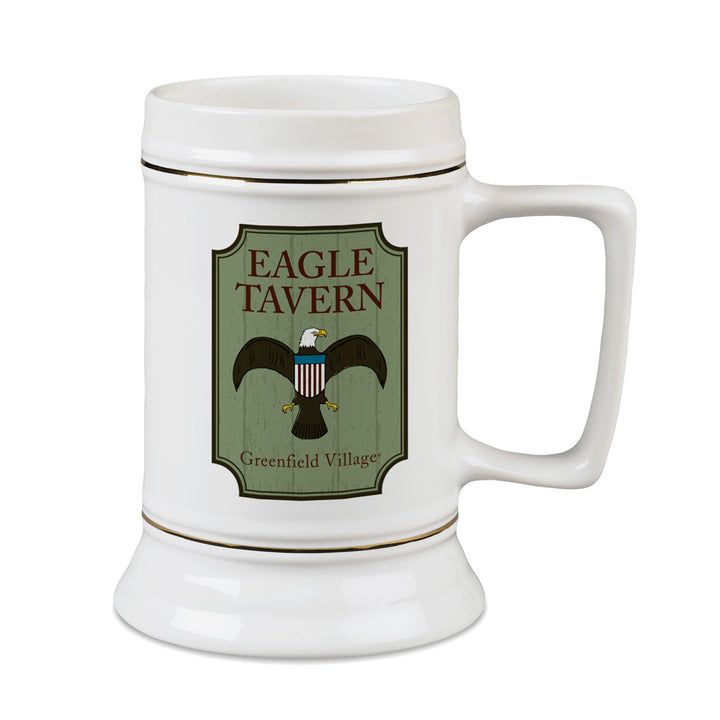 The Greenfield Village Eagle Tavern Stein is a white ceramic stein showcasing an eagle illustration and Greenfield Village logo on a green background—a perfect tribute to the spirit of 19th-century America.