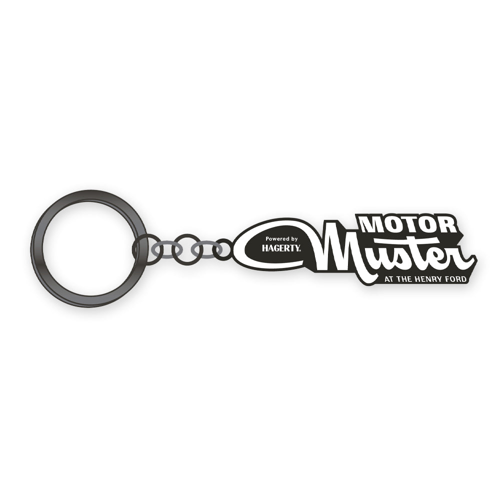 Celebrate the Greenfield Village 2026 Motor Muster with this vintage-inspired keychain featuring a black and white tag reading “MOTOR Muster AT THE HENRY FORD,” attached to a metal keyring by a short chain.