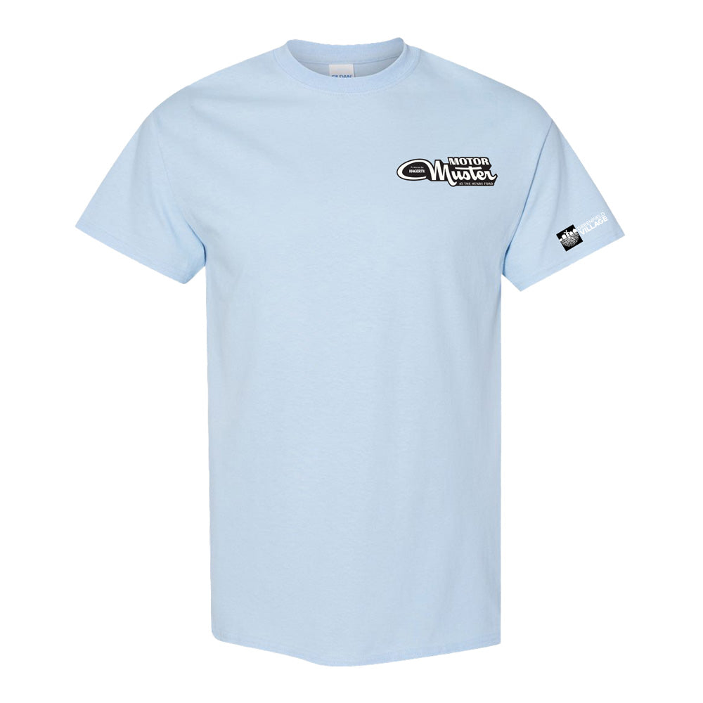 The Greenfield Village 2026 Motor Muster T-Shirt is a light blue short-sleeve tee with the “Motor Muster” logo on the left chest and a black-and-white patch on the sleeve, inspired by Motor Muster’s rich automotive history.