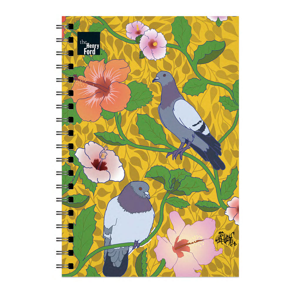 The Roberto Lugo Pigeon Art Journal spiral notebook features two pigeons on leafy branches with bright hibiscus flowers over a yellow patterned background and includes The Henry Ford Museum logo in the top left corner.