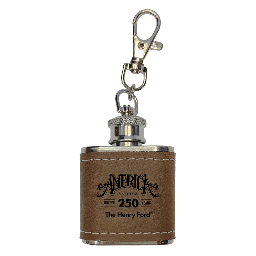 The Henry Ford® 1776 Concert Series Mini Flask features a brown leather cover, keychain clip, and "America 250 Years" text—an ideal history keepsake from the concert series.