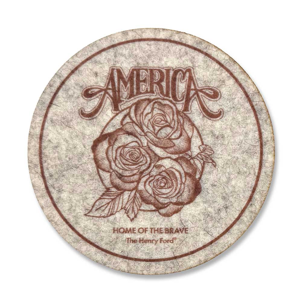 The Henry Ford® America’s 250th Coaster in grey features three roses, “AMERICA” above, and “HOME OF THE BRAVE The Henry Ford” below. Celebrate history with this commemorative round coaster from The Henry Ford Museum!.