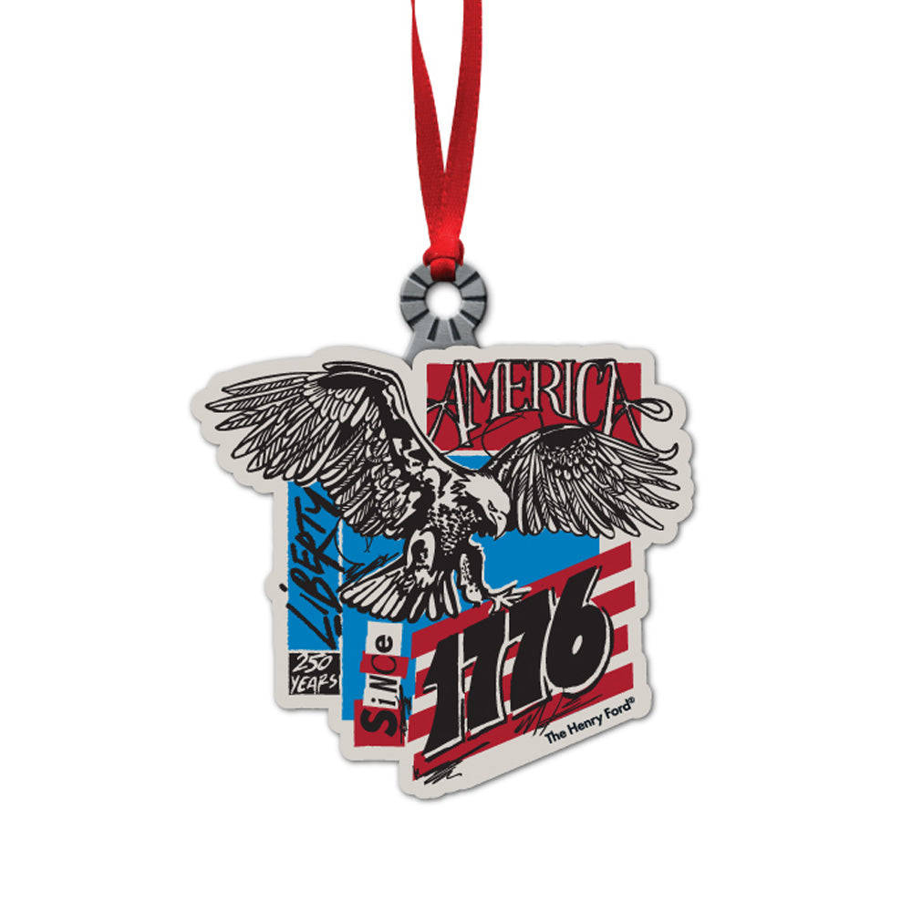 Celebrate freedom with The Henry Ford® 1776 Concert Series Ornament, featuring a flying eagle, red and blue stripes, and "America, Liberty, Since 1776, 250 Years." This patriotic keepsake hangs proudly by a red ribbon.