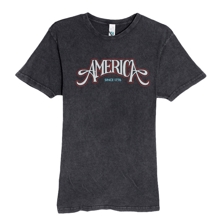 The Henry Ford® America's Birthday Concert Tour T-Shirt is a faded black limited-edition tee featuring "AMERICA" in bold white and red letters, with "SINCE 1776" below—perfect for collectors of patriotic apparel.