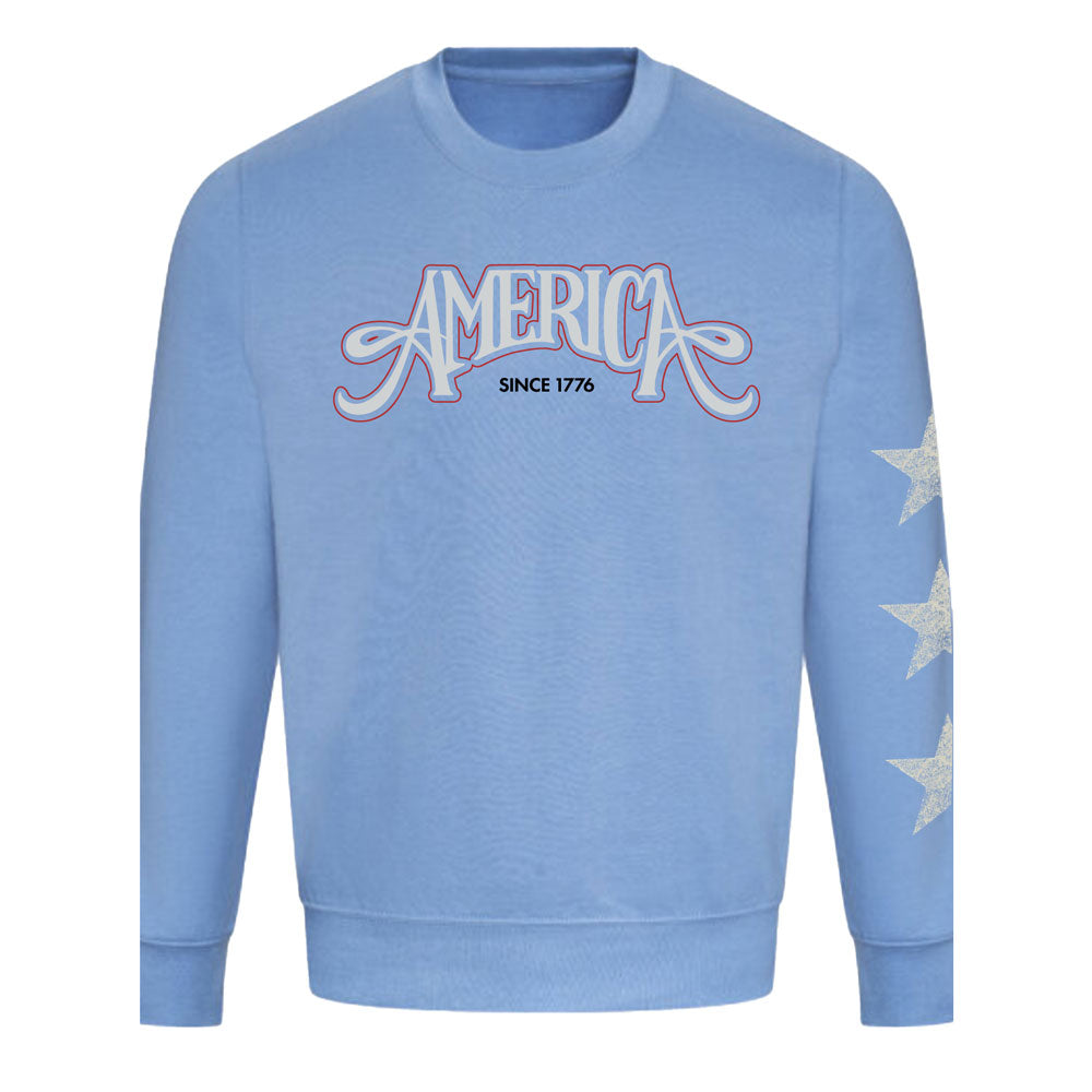 Celebrate America's 250th in style with The Henry Ford® America's Birthday Concert Tour Crew Sweatshirt—a light blue crew featuring "AMERICA SINCE 1776" on the chest and three white stars on the left sleeve for a festive look.