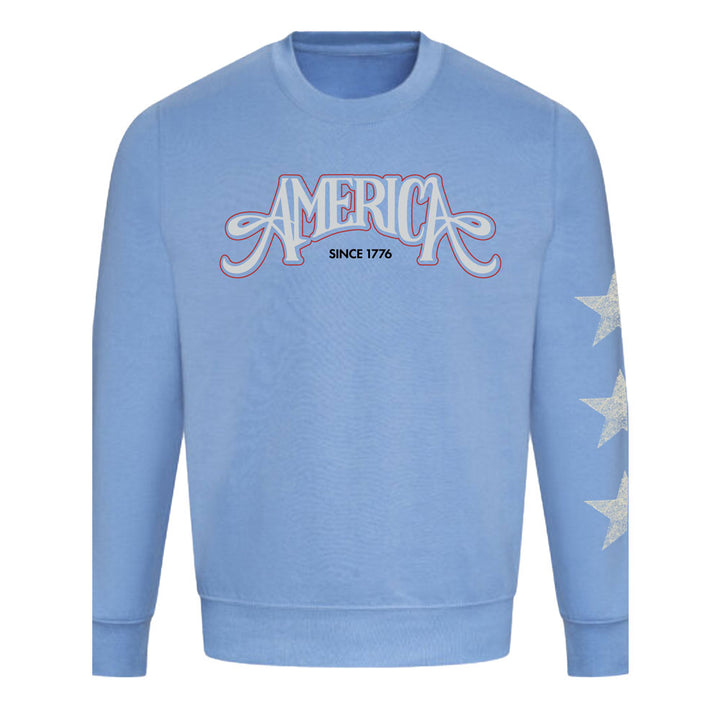 Celebrate America's 250th in style with The Henry Ford® America's Birthday Concert Tour Crew Sweatshirt—a light blue crew featuring "AMERICA SINCE 1776" on the chest and three white stars on the left sleeve for a festive look.