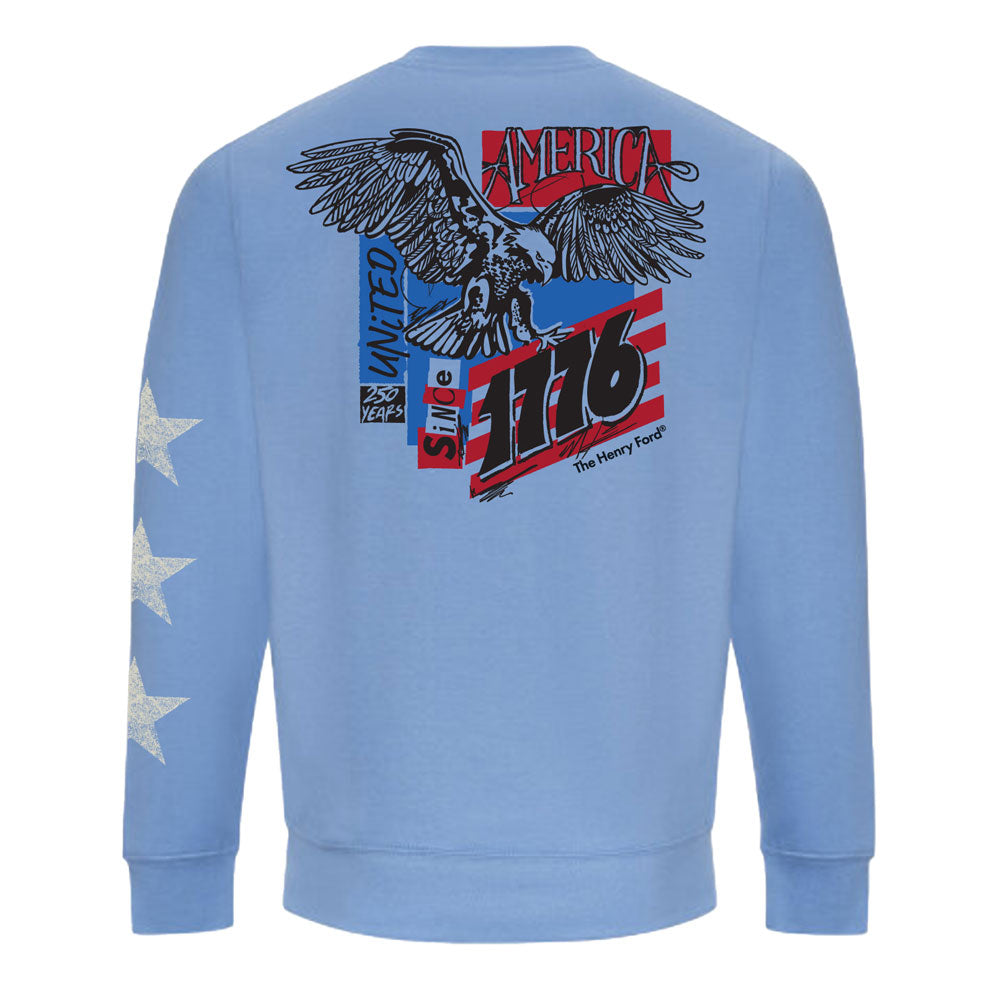 Celebrate America’s 250th in The Henry Ford® America's Birthday Concert Tour Crew Sweatshirt—a light blue crew with three white stars on one sleeve and a bold eagle graphic on the back, honoring classic Americana since 1776.