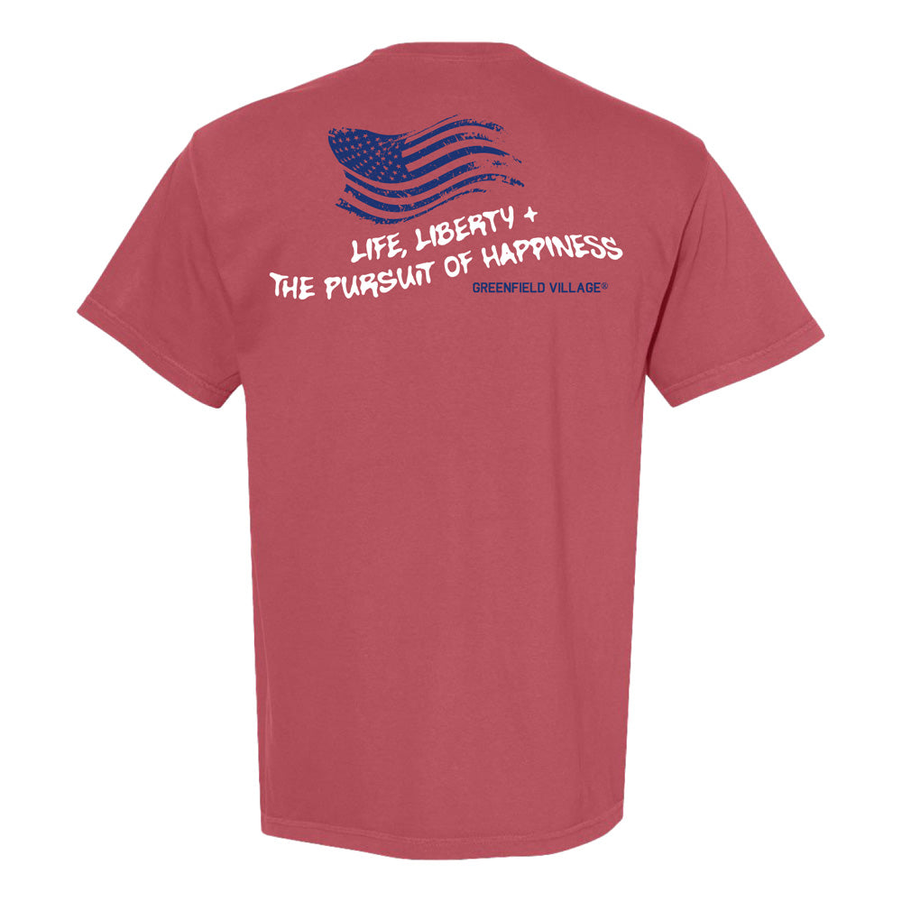 Celebrate America's 250th in style with the Greenfield Village Life & Liberty T-Shirt—red, with a blue stylized American flag on the front and "Greenfield Village" printed on the back.