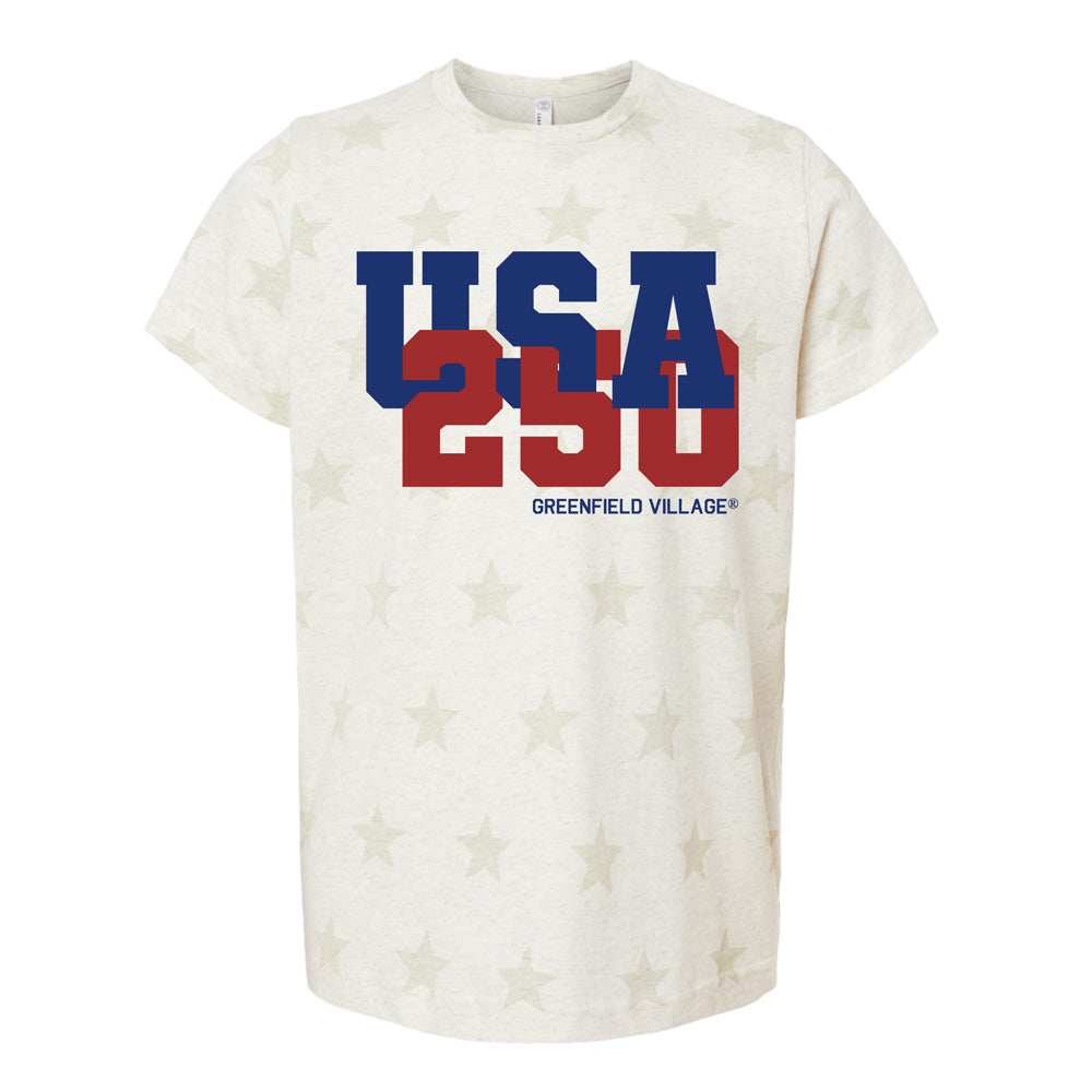 The Greenfield Village America's 250th Star Youth T-Shirt is cream-colored with a subtle star pattern, bold blue USA and red 250 text on the chest, and "Greenfield Village" printed below to mark America's 250th anniversary.
