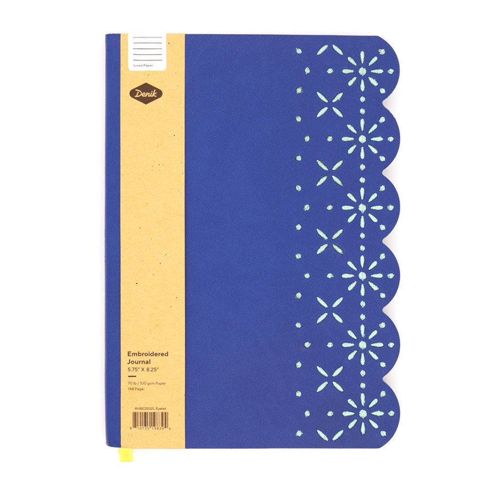 The Eyelet Embroidered Journal features a blue cover with scalloped edges, a floral cutout pattern on the right, a brown label reading "Embroidered Journal," size 5.75 x 8.25, and quality lined pages.