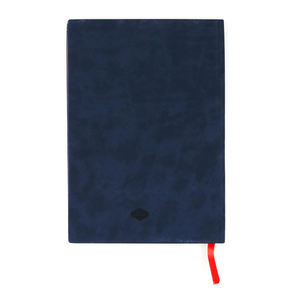 The Evelyn Blue Embroidered Journal is a closed, dark blue vegan leather notebook featuring a small black emblem on the cover and a red ribbon bookmark, displayed on a white background.