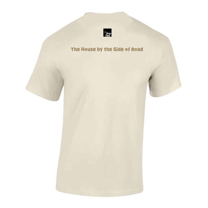 Greenfield Village Jackson Home T-Shirt in beige, shown from the back with "The House by the Side of Road" printed across the upper back and a small black-and-white square Americana logo centered near the neckline.