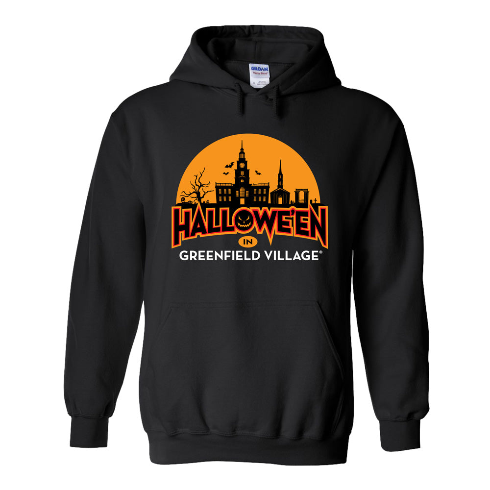 The Henry Ford® Greenfield Village Halloween Glow Hooded Sweatshirt is a black glow-in-the-dark hoodie featuring an orange haunted house silhouette, bats, and the text “HALLOWEEN IN GREENFIELD VILLAGE” on the front—perfect for celebrating Greenfield Village Halloween in style.
