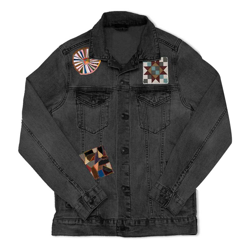 The Quilt Patches Denim Jacket for women features three colorful quilt-style patches—circle on the right shoulder, square geometric on the left chest, and another square patch on the lower right—each inspired by Henry Ford Museum designs.