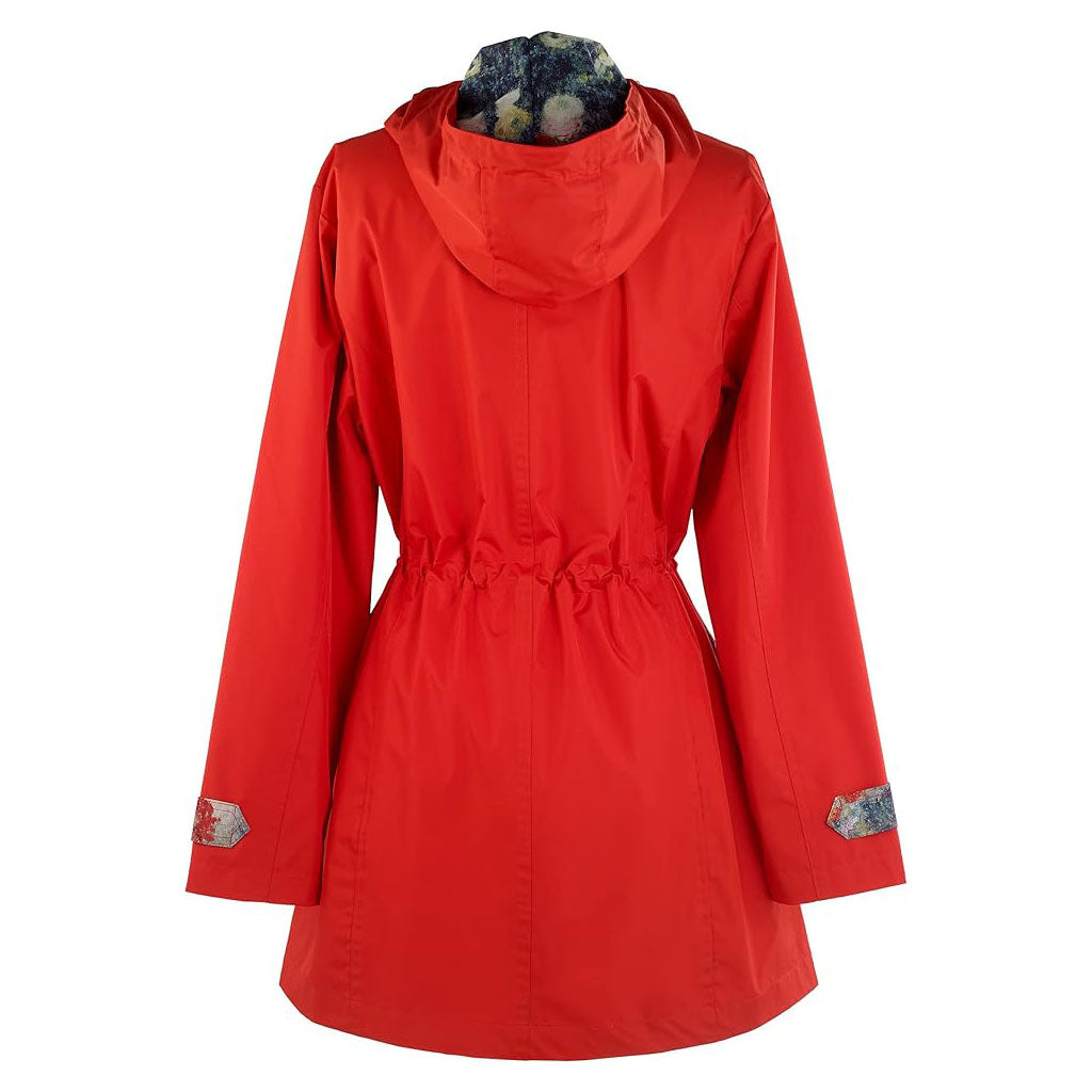The Jardin Raincoat is a bright red women’s jacket with a hood, adjustable waist, and patterned sleeve cuffs, shown from the back. This stylish water-repellent coat keeps you dry and chic in any weather.