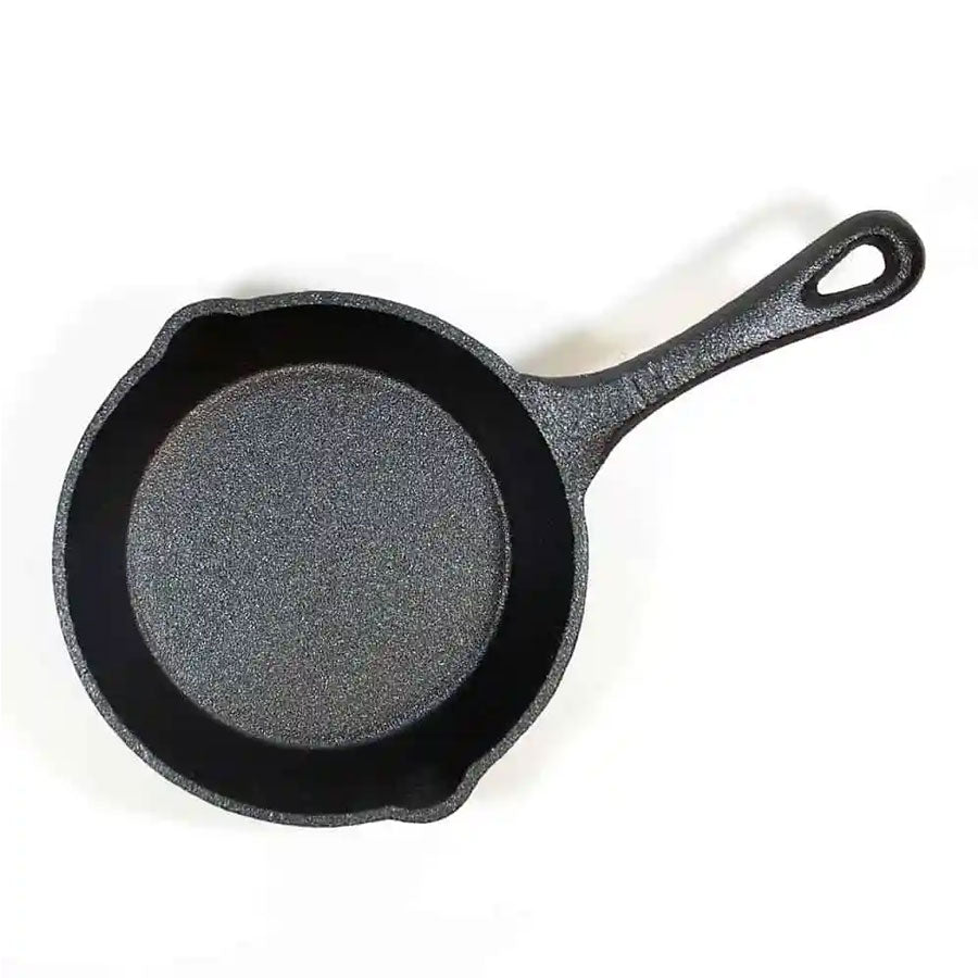 The Cast Iron 6.5" Skillet is black, pre-seasoned, with a handle and dual pouring spouts. It’s induction compatible and shown on a white background—perfect for all your versatile cast iron cooking needs.