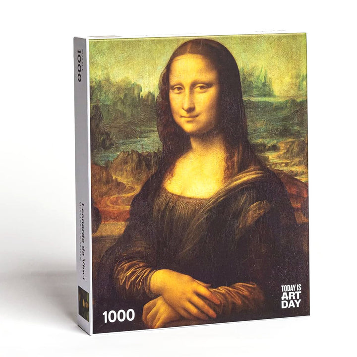 The Leonardo Da Vinci - Mona Lisa Puzzle is a 1000-piece art puzzle featuring the iconic painting on the box cover, branded with “Today is Art Day” in the bottom right corner—perfect for any Mona Lisa fan.