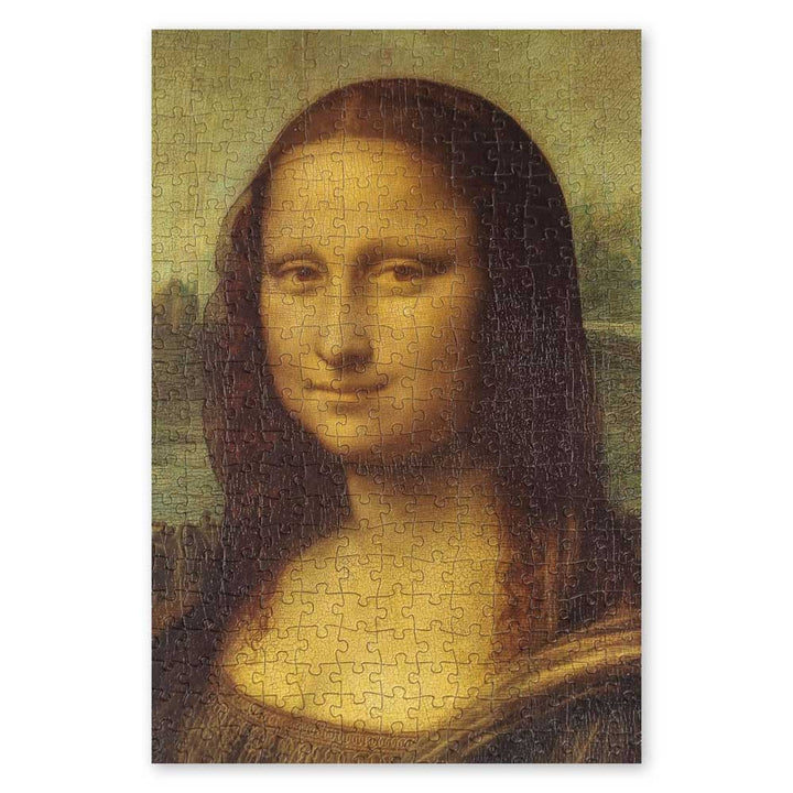The Leonardo Da Vinci - Mona Lisa Puzzle is a completed 1000-piece jigsaw featuring the iconic woman's serene expression and subtle smile, with puzzle piece lines visible across the renowned artwork.