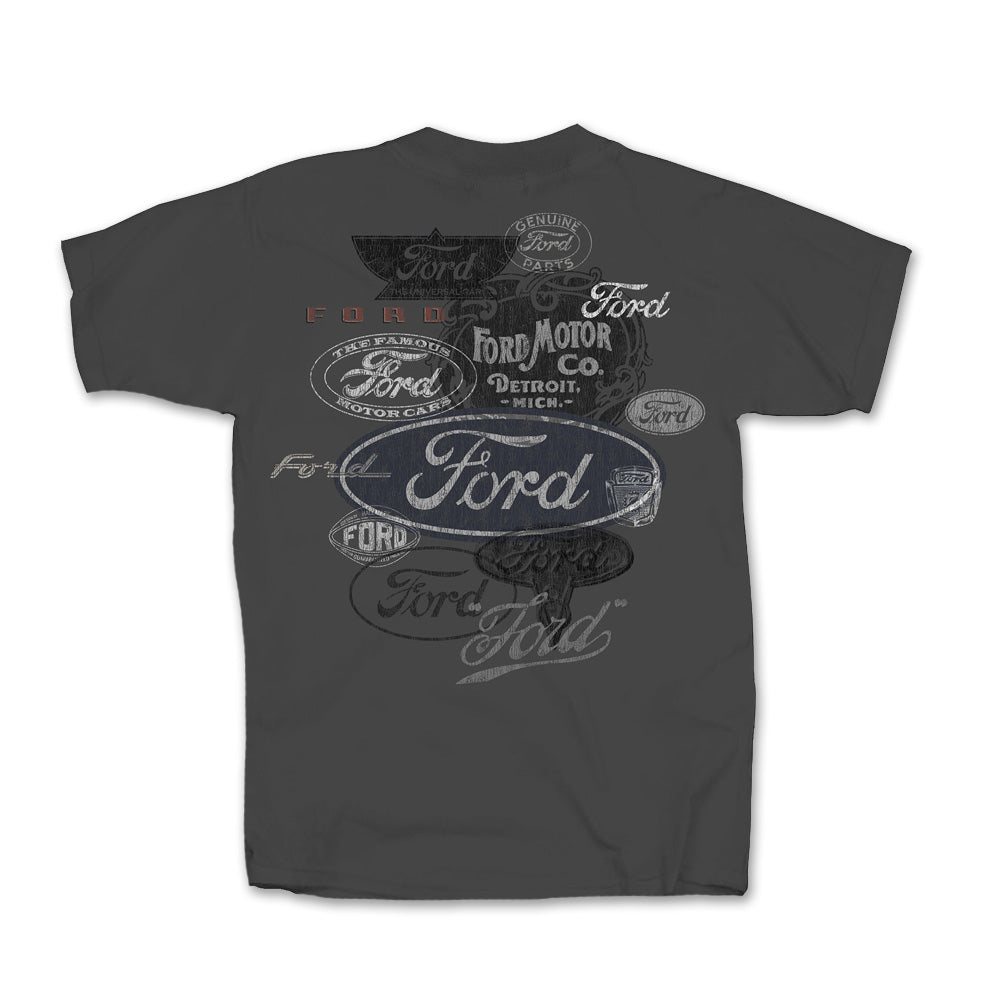 The Ford Vintage Sign T-Shirt is a dark gray shirt showcasing an array of classic Ford logos in black, white, gray, and blue, overlapping in a striking pattern across the back.