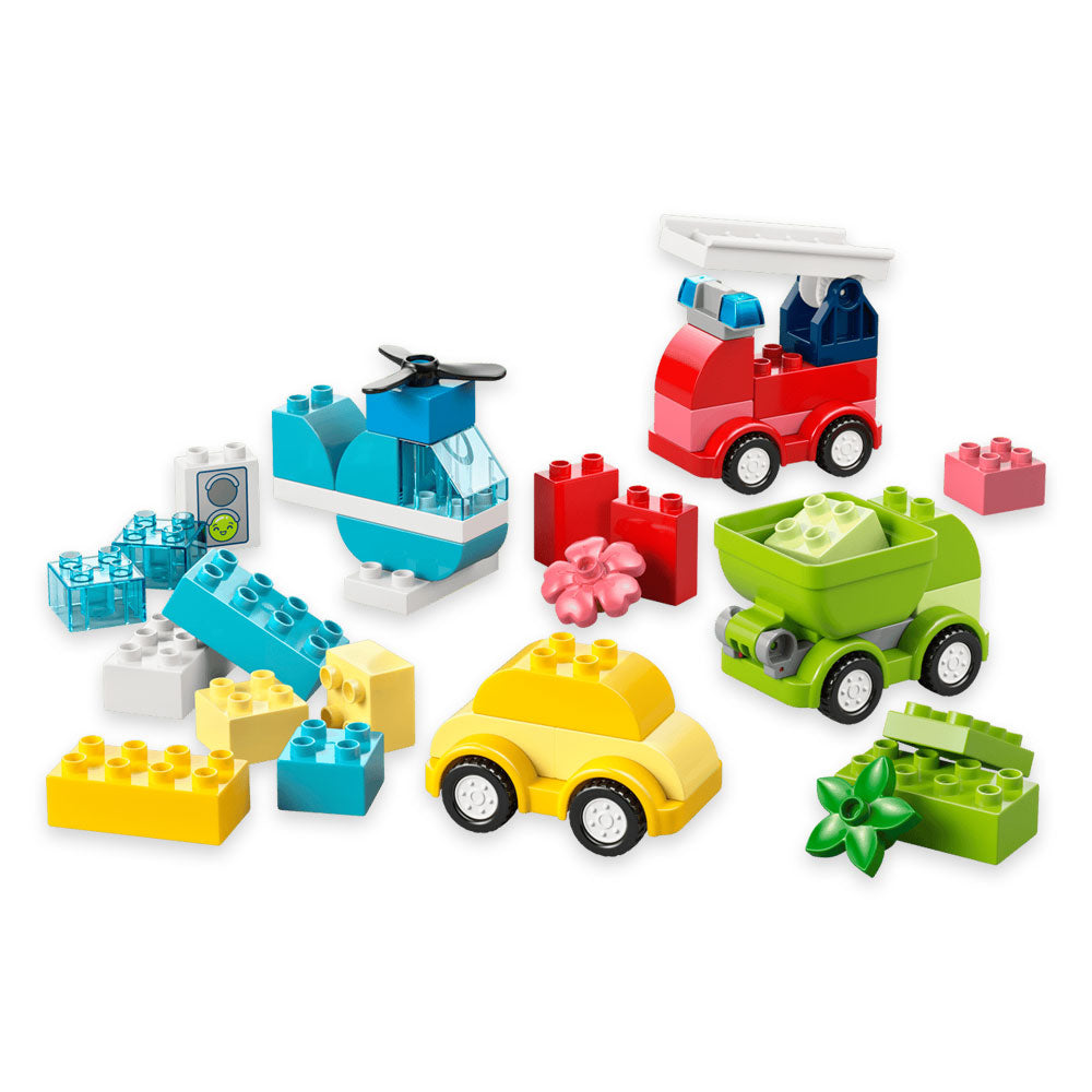 A vibrant collection of colorful plastic blocks from the LEGO DUPLO Creative Vehicles set are arranged to construct a yellow car, green dump truck, red fire truck, blue helicopter, and other fun accessories against a white background. Designed for toddlers, this building set sparks imagination and hands-on play while encouraging endless creativity in young builders.