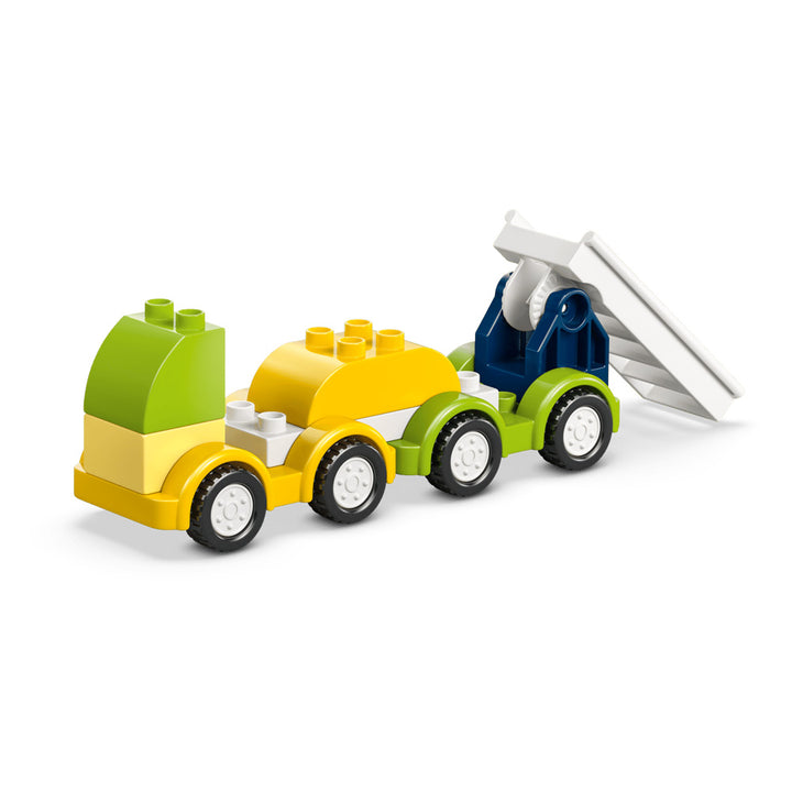 The LEGO DUPLO Creative Vehicles set is a colorful toy truck made from interlocking building blocks in green, yellow, white, and blue. It features a white tilting bed at the back and four sets of black wheels, making it perfect for inspiring imaginative play with creative vehicles!.