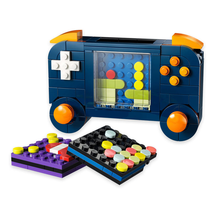 Introducing the LEGO Retro Gaming Console—a toy game controller crafted from LEGO bricks, featuring bright orange buttons and two removable, colorful grid panels displayed up front. Perfect for fans of retro gaming aesthetics, this set is ideal for builders using the LEGO Builder app or anyone looking to expand their collection with an imaginative addition from the LEGO Creator 3 in 1 series.
