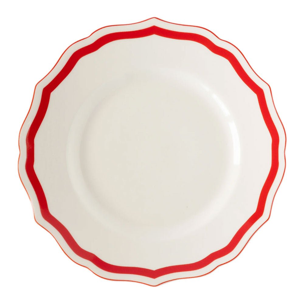 The Red Icing on the Cake Salad Plate is crafted from chip-resistant porcelain and features a white center with a scalloped edge, highlighted by a bold red wavy border around the rim. Its plain, unadorned center adds elegance and versatility to your dinnerware collection.