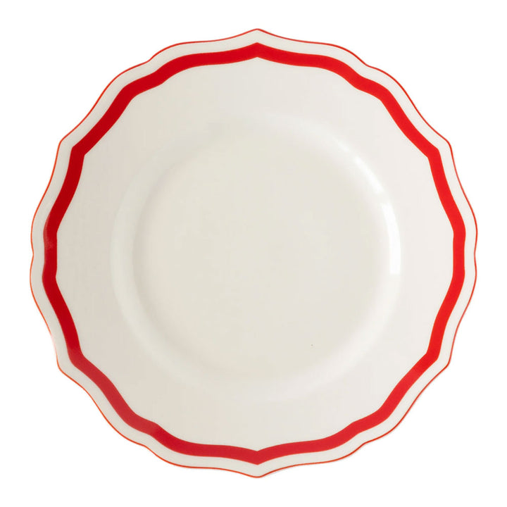 The Red Icing on the Cake Salad Plate is crafted from chip-resistant porcelain and features a white center with a scalloped edge, highlighted by a bold red wavy border around the rim. Its plain, unadorned center adds elegance and versatility to your dinnerware collection.