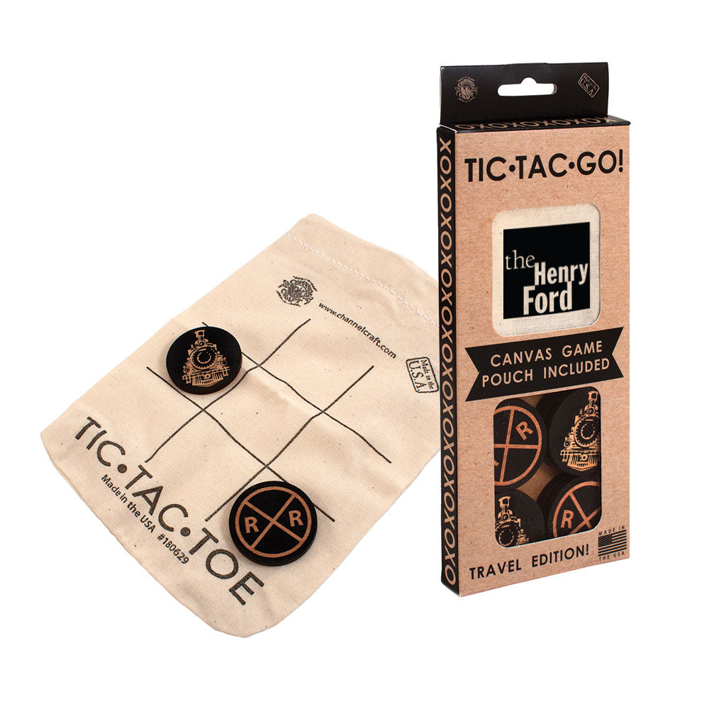 The Tic Tac Go Game is a canvas travel set with black and gold railroad tokens, a drawstring pouch printed with a grid, and comes in a branded “TIC-TAC-GO! The Henry Ford Travel Edition” box featuring The Henry Ford logo.