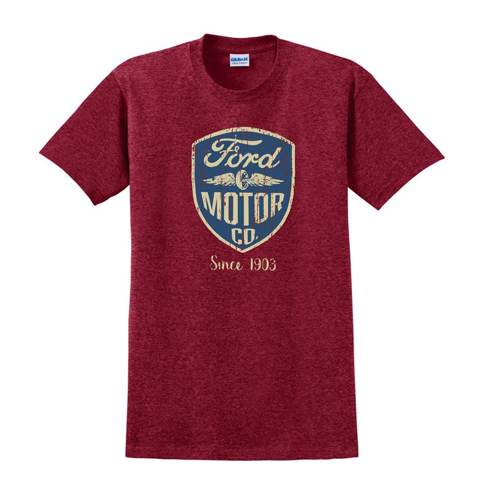 Introducing the Ford Wings T-Shirt—a maroon tee showcasing a blue and gold vintage-style “Ford Motor Co. Since 1903” logo on the chest. Perfect for Ford fans and classic car enthusiasts!.