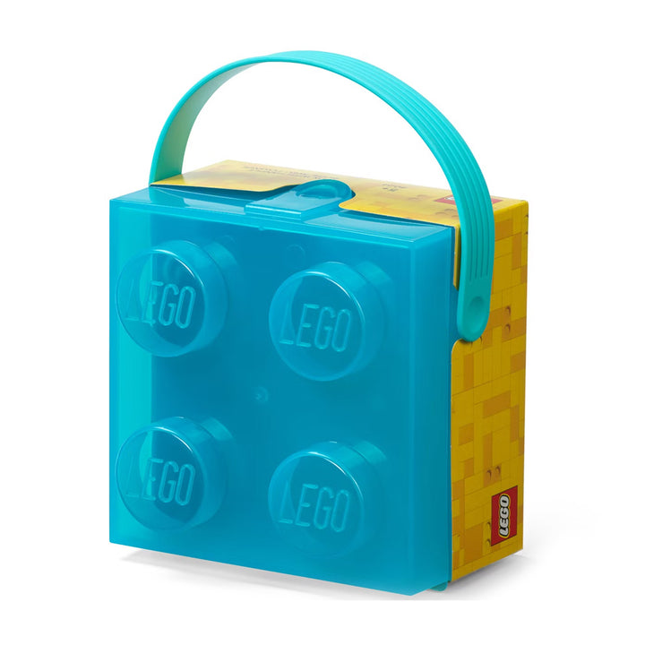 Introducing the LEGO Translucent Light Blue Storage Box, a stylish storage solution shaped like a classic LEGO brick. This lunchbox features a teal handle and yellow accents for added flair, with each stud showcasing the iconic LEGO logo. Perfect for keeping kids organized!.