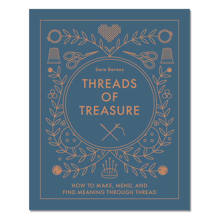 A blue cover book, Threads of Treasure: How to Make, Mend, and Find Meaning through Thread by Sara Barnes, features gold line drawings of sewing tools and plants—perfect for modern crafters exploring creative embroidery projects.