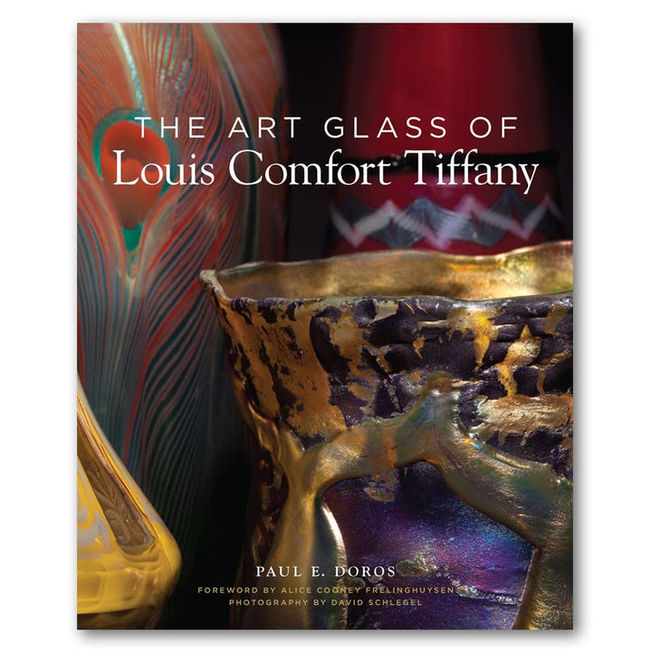 The cover of The Art Glass of Louis Comfort Tiffany showcases vibrant, detailed glass art, with the title and author’s name displayed prominently over the image.