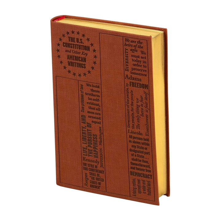 A brown hardcover edition of "U.S. Constitution and Other Key American Writings (Word Cloud Classics)" with embossed text and quotes on the cover; its yellow-tinted pages evoke the depth of American history.