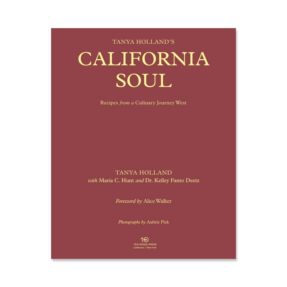 A maroon book cover with gold text displays the title, “Tanya Holland’s California Soul: Recipes from a Culinary Journey West,” along with author and contributor names. The publisher’s logo appears at the bottom.