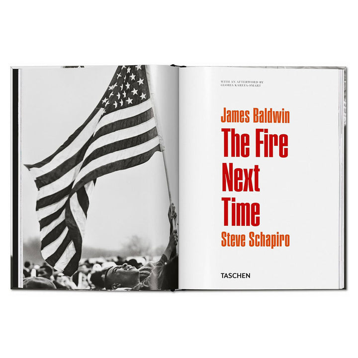 An open book displays a black-and-white civil rights photo with people holding an American flag and bold red text on the right reading "James Baldwin. Steve Schapiro. The Fire Next Time.