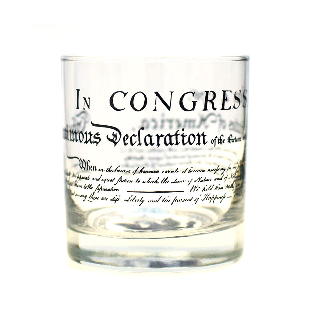 The U.S. Constitution Rocks Glass showcases black printed text replicating a portion of the historic document, featuring phrases from the U.S. Constitution.