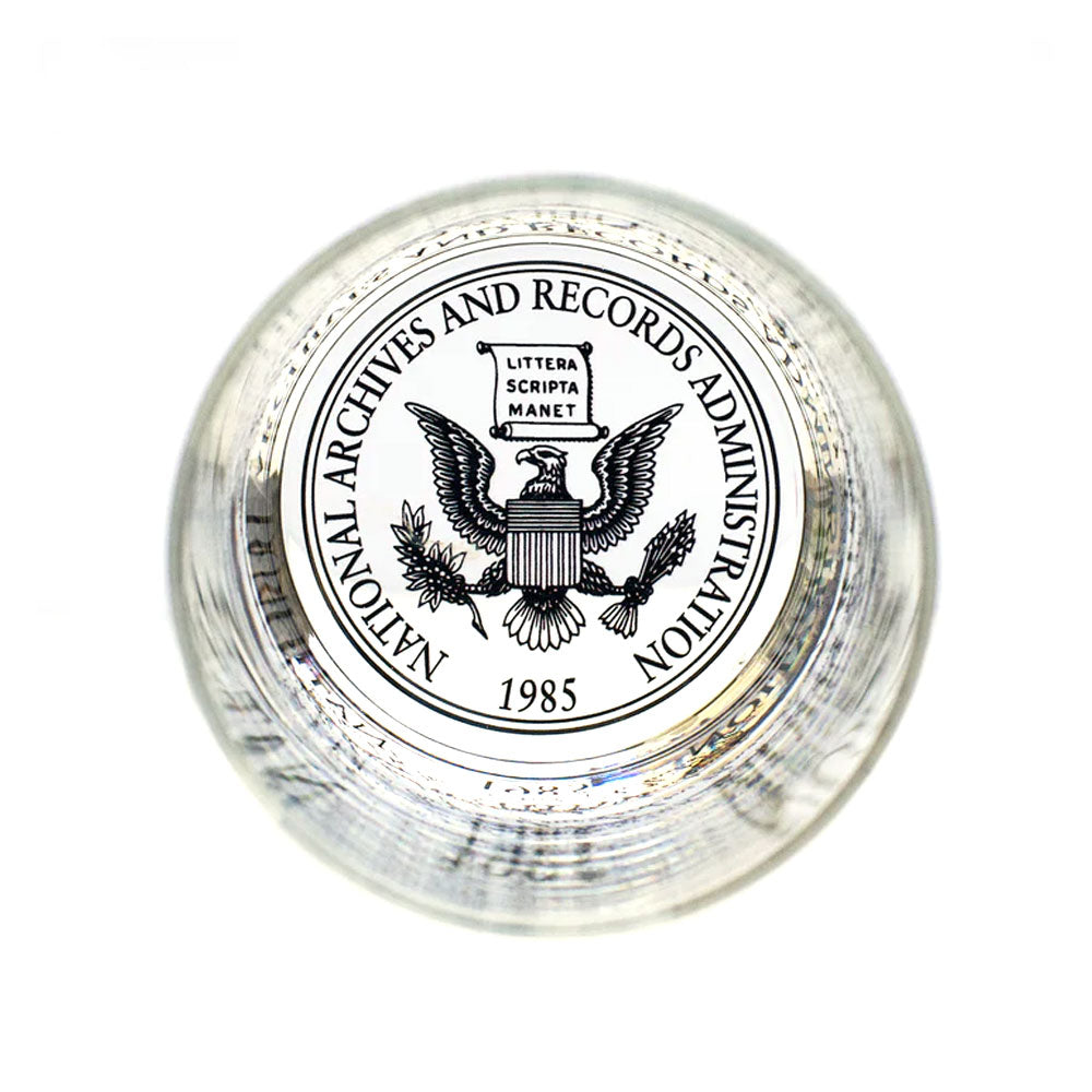 A glass paperweight featuring the National Archives seal with an eagle, shield, "Littera Scripta Manet," and 1985—an ideal match for your U.S. Constitution Rocks Glass collection.