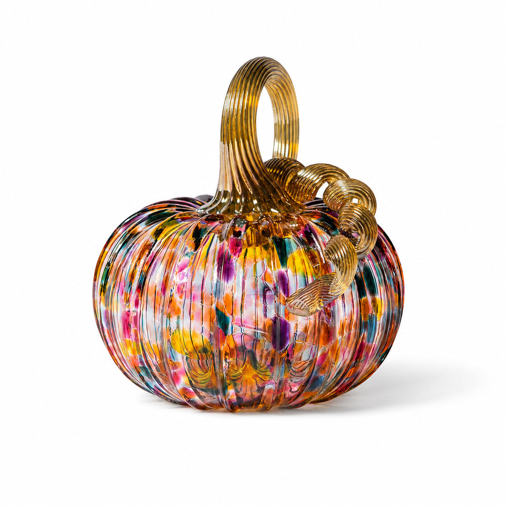 The Small Glass Pumpkin - Kaleidoscope is a vibrant, ribbed hand-blown glass pumpkin with a golden stem and curly vine, adorned with splashes of red, yellow, blue, and green on a white background—an exquisite collectible keepsake reminiscent of the artistry found at Greenfield Village.
